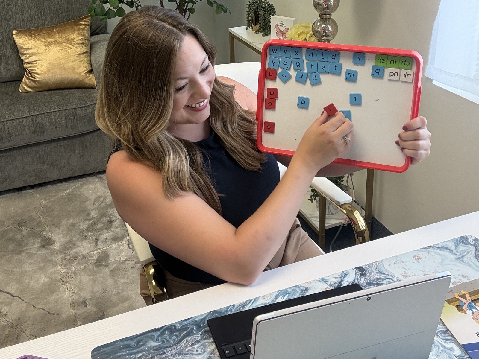 Elise, founder of LitTrack, teaching an online reading lesson with a magnetic letter tile board